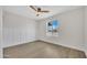 Bright bedroom with modern trim, ceiling fan, and wood-look flooring at 3614 W Danbury Dr, Glendale, AZ 85308