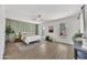 Spacious bedroom with stylish green accent wall, a ceiling fan, and multiple windows for natural light at 3614 W Danbury Dr, Glendale, AZ 85308