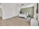 Bright bedroom with a statement wall, ceiling fan, and plenty of open space at 3614 W Danbury Dr, Glendale, AZ 85308