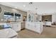 Bright kitchen boasts white cabinetry, stainless steel appliances, quartz countertops, and eat-in island at 3614 W Danbury Dr, Glendale, AZ 85308