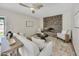 Inviting living room features a charming brick fireplace, neutral-toned furniture, and lots of natural light at 3614 W Danbury Dr, Glendale, AZ 85308
