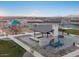 Community aerial view featuring a playground, picnic area, outdoor fireplace and multiple sports courts at 36955 W Santa Maria St, Maricopa, AZ 85138