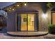 Inviting back patio with sliding glass doors and string lights above the tiled seating area at 3713 W Nancy Ln, Phoenix, AZ 85041