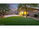 Backyard featuring artificial grass, mature landscaping and a covered patio at 3713 W Nancy Ln, Phoenix, AZ 85041