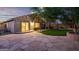 Backyard featuring artificial grass, a stone patio, and outdoor lighting at 3713 W Nancy Ln, Phoenix, AZ 85041