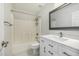 Bathroom with a tub/shower, white vanity and framed mirror at 3713 W Nancy Ln, Phoenix, AZ 85041