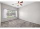 Bright bedroom featuring neutral paint, a ceiling fan, and a window that lets in natural light at 3713 W Nancy Ln, Phoenix, AZ 85041