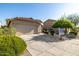 Front exterior featuring a two-car garage, long driveway, and simple desert landscaping at 3713 W Nancy Ln, Phoenix, AZ 85041