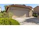 Close up of a house with a two-car garage and desert landscaping at 3713 W Nancy Ln, Phoenix, AZ 85041