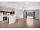 Open-concept living room featuring tile floors, a kitchen bar, and bright lighting at 3713 W Nancy Ln, Phoenix, AZ 85041