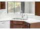 A shiny stainless steel sink and modern faucet, set against a white subway tile backsplash at 3713 W Nancy Ln, Phoenix, AZ 85041