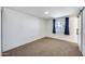 An expansive bedroom with a window, sliding door, and neutral carpeting at 3801 E Captain Dreyfus Ave, Phoenix, AZ 85032