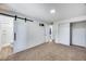 Large bedroom featuring a sliding barn door to the bathroom and closet at 3801 E Captain Dreyfus Ave, Phoenix, AZ 85032