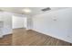 Bright dining area with wood-look flooring adjacent to an all-white kitchen at 3801 E Captain Dreyfus Ave, Phoenix, AZ 85032