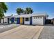 Charming single-story home featuring blue siding, white trim, and a vibrant yellow front door at 3801 E Captain Dreyfus Ave, Phoenix, AZ 85032