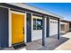 Close-up of the yellow front door with address, white trim, and adjacent garage at 3801 E Captain Dreyfus Ave, Phoenix, AZ 85032
