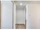 Bright hallway featuring wood-look flooring and crisp white walls and trim at 3801 E Captain Dreyfus Ave, Phoenix, AZ 85032