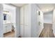 Hallway with wood-look flooring and leads to a bathroom with a white vanity at 3801 E Captain Dreyfus Ave, Phoenix, AZ 85032