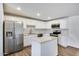 This kitchen features stainless steel appliances, a white island, and white cabinets at 3801 E Captain Dreyfus Ave, Phoenix, AZ 85032