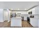 This kitchen has stainless steel appliances, a kitchen island, and white cabinets at 3801 E Captain Dreyfus Ave, Phoenix, AZ 85032