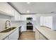 The updated kitchen includes stainless steel appliances and white cabinets at 3801 E Captain Dreyfus Ave, Phoenix, AZ 85032