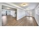 Spacious layout featuring wood-look floors, connecting the living room to the kitchen and backyard at 3801 E Captain Dreyfus Ave, Phoenix, AZ 85032