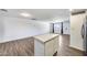 This open concept features new flooring, white walls, and a kitchen island at 3801 E Captain Dreyfus Ave, Phoenix, AZ 85032