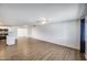 Open-concept living room featuring wood-look flooring, a ceiling fan, and ample natural light at 3801 E Captain Dreyfus Ave, Phoenix, AZ 85032
