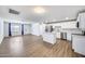 Bright, open-concept living room and kitchen featuring stainless steel appliances and wood-look flooring at 3801 E Captain Dreyfus Ave, Phoenix, AZ 85032