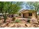 Low-maintenance backyard features desert landscaping and a covered patio, perfect for outdoor living at 40066 W Jenna Ln, Maricopa, AZ 85138