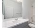 Bathroom features a gray vanity with a white sink and quartz countertop at 40066 W Jenna Ln, Maricopa, AZ 85138
