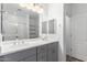Bathroom features double sinks, quartz countertops, and a glass enclosed shower at 40066 W Jenna Ln, Maricopa, AZ 85138