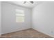 Bright bedroom features neutral carpet, and plenty of natural light from multiple windows at 40066 W Jenna Ln, Maricopa, AZ 85138
