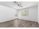 Bedroom with wood-look floors, bright natural light and access to the backyard at 40066 W Jenna Ln, Maricopa, AZ 85138
