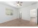 Bedroom with carpet, ceiling fan, window, and ample natural light at 40066 W Jenna Ln, Maricopa, AZ 85138