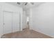 Bright bedroom features neutral carpet, and a closet with sliding doors at 40066 W Jenna Ln, Maricopa, AZ 85138