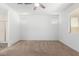 Neutral bedroom with carpet flooring, light walls, and windows offering natural light at 40066 W Jenna Ln, Maricopa, AZ 85138