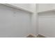 Walk in closet features hanging rods for optimal clothing organization at 40066 W Jenna Ln, Maricopa, AZ 85138