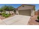 Well-maintained single-story home with desert landscaping, a two-car garage and a welcoming entrance at 40066 W Jenna Ln, Maricopa, AZ 85138