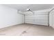 Attached garage with concrete floor and garage door at 40066 W Jenna Ln, Maricopa, AZ 85138