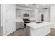 Modern kitchen featuring an island, quartz counters, and stainless steel appliances at 40066 W Jenna Ln, Maricopa, AZ 85138