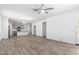 Spacious living room featuring stylish wood-look floors and a ceiling fan for added comfort at 40066 W Jenna Ln, Maricopa, AZ 85138