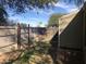 Fully fenced backyard with trees and a brick trim next to the home at 4042 E Carson Rd, Phoenix, AZ 85042