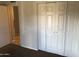 Bedroom featuring carpet floors, large closet, and doorway into adjacent room at 4042 E Carson Rd, Phoenix, AZ 85042