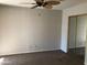 Neutral bedroom featuring carpet flooring, ceiling fan and mirrored closet doors at 4042 E Carson Rd, Phoenix, AZ 85042