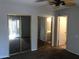 This bedroom features two mirrored sliding door closets and neutral paint at 4042 E Carson Rd, Phoenix, AZ 85042