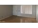 Bedroom featuring a large window, neutral wall color, and hardwood flooring at 4042 E Carson Rd, Phoenix, AZ 85042
