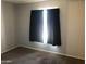 Neutral bedroom featuring carpet flooring and large window allowing plenty of natural light at 4042 E Carson Rd, Phoenix, AZ 85042