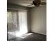 Bright bedroom with sliding doors leading to an outdoor space and a ceiling fan at 4042 E Carson Rd, Phoenix, AZ 85042