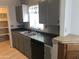 Functional kitchen featuring a dual stainless sink, gray cabinetry and black dishwasher at 4042 E Carson Rd, Phoenix, AZ 85042